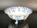 a blue and white bowl sitting on top of a black table