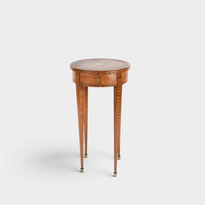 a small round table with a marble top and legs