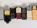 a lot of different colored toy trains on a white surface