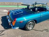 an image of a blue convertible car parked in a parking lot