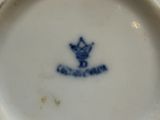 a blue and white plate with a crown on it