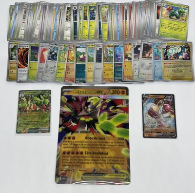 a lot of pokemon cards on the table with a lot of them