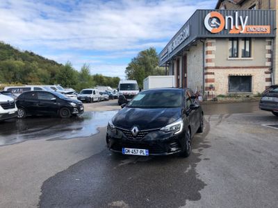 a black car parked in front of a building in a parking lot