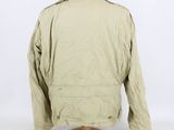 the back view of a beige jacket on a mannequin stand