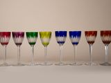 six different colored wine glasses lined up in a row