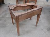 a small wooden table with a wooden seat on it