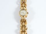 an image of a close up of a wrist watch on a white surface