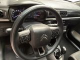the interior of a car with a steering wheel and dashboard controls