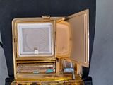 a gold case with a mirror on top of it
