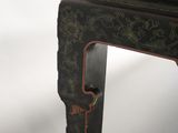 a black table with a red and gold design on it
