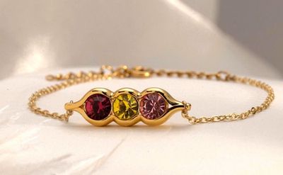 a close up of a bracelet with three stones on it