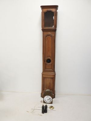 a grandfather clock sitting next to a tall wooden grandfather clock