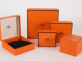 a group of orange boxes with black trims on a white surface