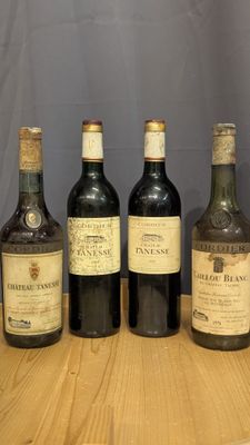four bottles of wine are lined up on a wooden table