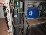 a metal shelf with a blue box on top of it
