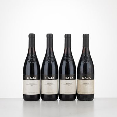 three bottles of red wine sitting on top of a table