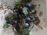 a white bowl with a bunch of berries on it