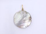 a white mother of pearl pendant on a white background