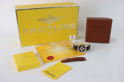 breitling watch with box and papers on white table
