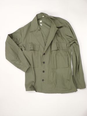 an olive green military jacket with buttons and buttons on the chest