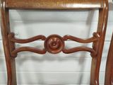 a wooden chair that has a wooden seat on it