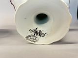 a white vase with a black and white design on it