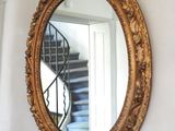 a mirror hanging on the wall next to a stair case