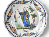 a plate with a picture of a saint on it