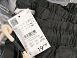 a label on a pair of pants that is on a plastic bag