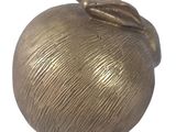 a gold apple with a leaf on top of it