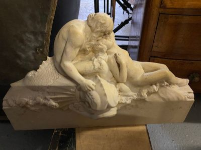 une statue représentant un homme et une femme assis sur un rocher