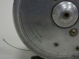 a close up of a metal object on a white surface