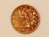 a gold coin with the head of a woman on it