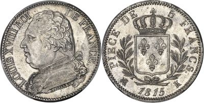 a silver coin with a crown on top of it