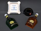 three bottles of liquor sitting next to each other on a table
