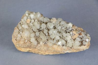 a rock with a lot of white crystals on it