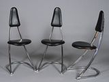 pair of chrome and black leather chairs with black leather seats