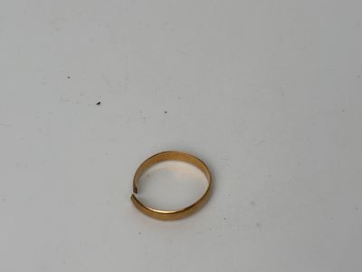 a close up of a gold ring on a white surface