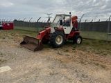 a tractor that is parked on the side of the road