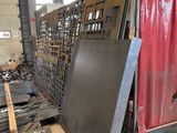 a man that is standing in front of a pile of metal