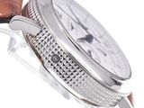 a close up of a watch with a brown leather strap