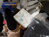 a pile of clothes and shoes on the floor