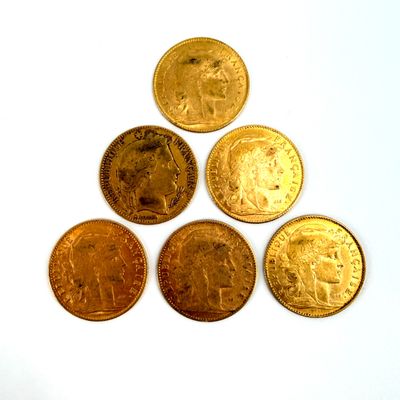 six different types of gold coins on a white surface