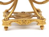 a close up of a gold plate with a clock on it