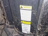 a close up of a black door with a yellow sticker on it