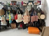 many bags hanging on a rack in a room