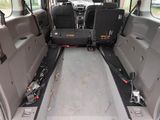 the interior of a van with two seats and a seat belt