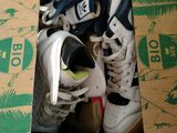 many pairs of shoes in a box on the floor