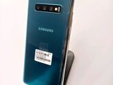 the back of a blue samsung s10 with a barcode sticker on it