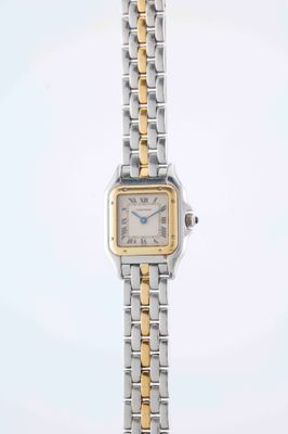 a close up of a wrist watch with a gold and silver bracelet
